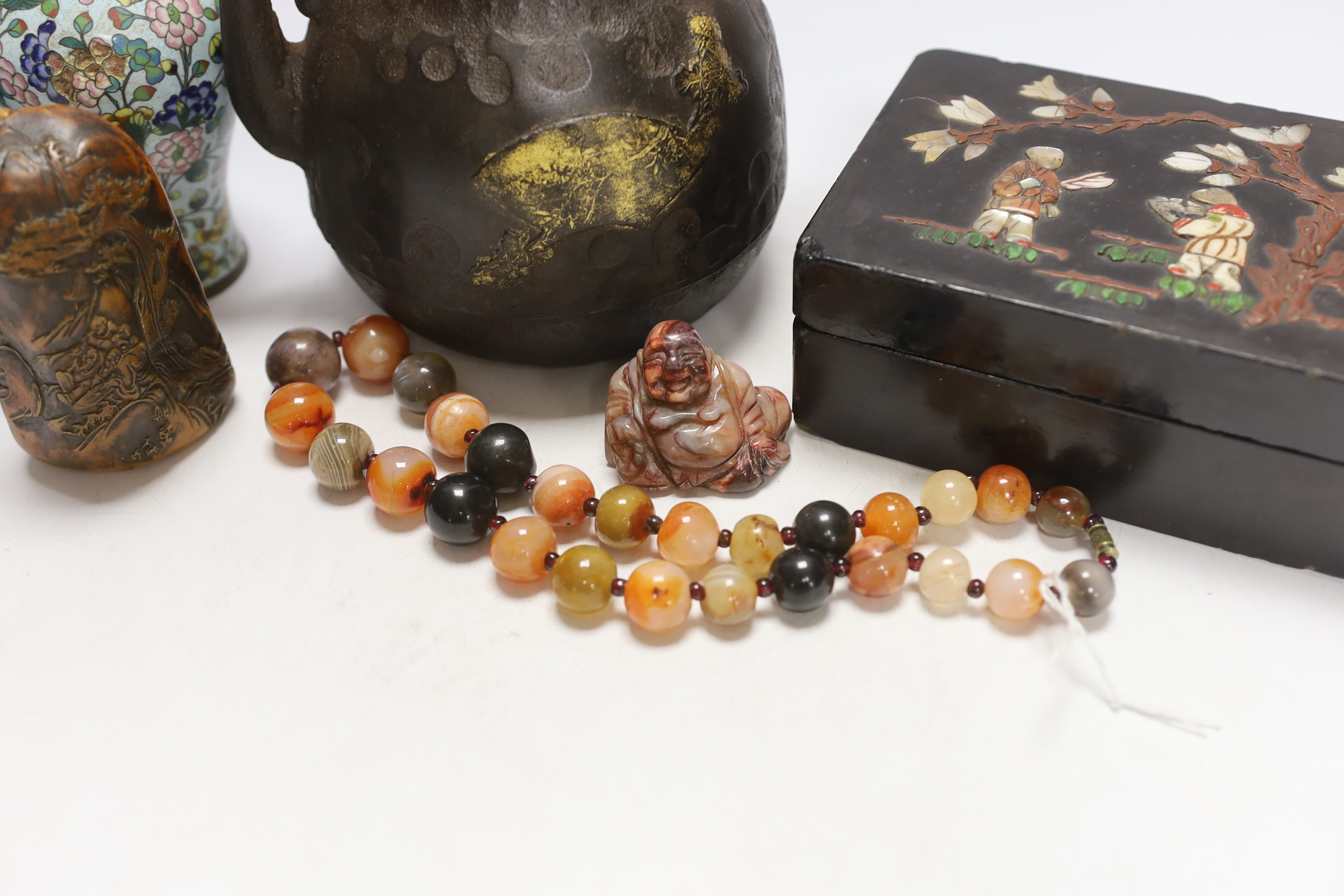 A Japanese iron tetsubin kettle with gilt decoration, a pair of Chinese cloisonné enamel vases, 12.5cm, a lacquered box with mother of pearl inlay, a carved black stone disc, 5cm diameter, a miniature ceramic pot and an